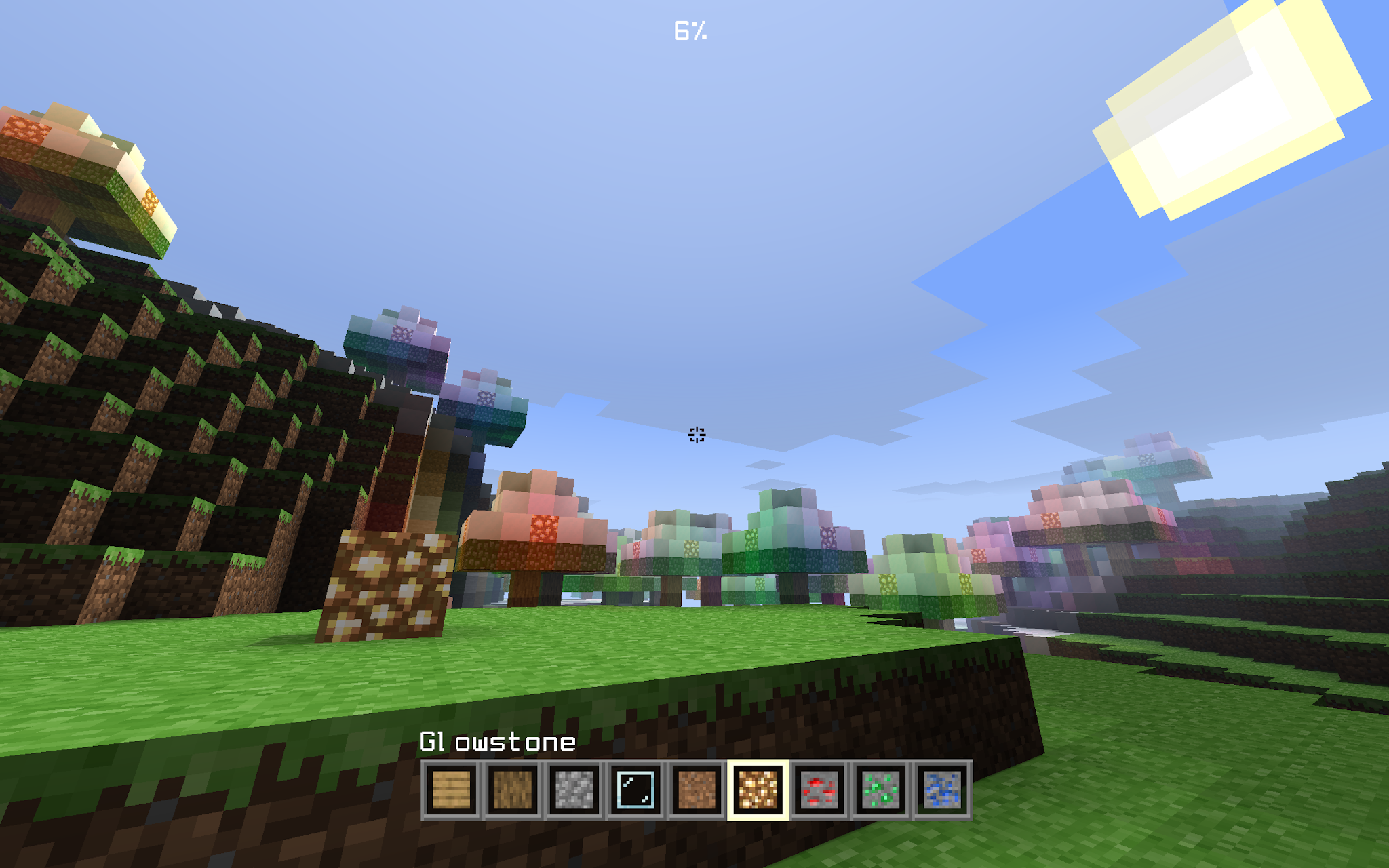 The sun is rising on a hill. Trees with colored lights are in the distance. Clouds are in the sky. The player has glowstone selected in their hotbar.